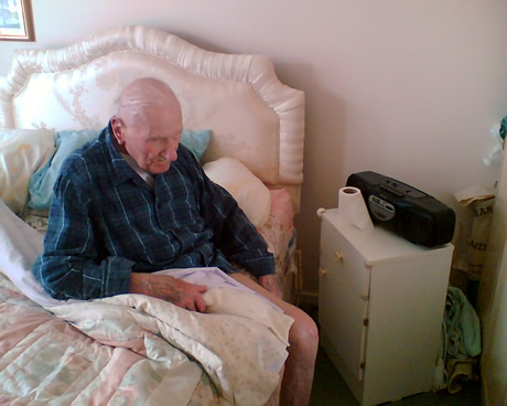 Grandpa sitting on his bed